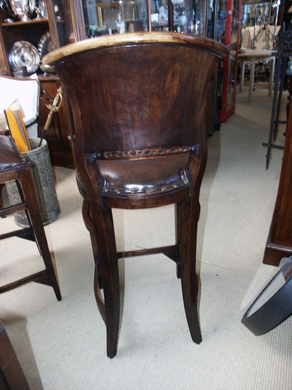 Great looking pair of carved wood and leather with tack design bar stools