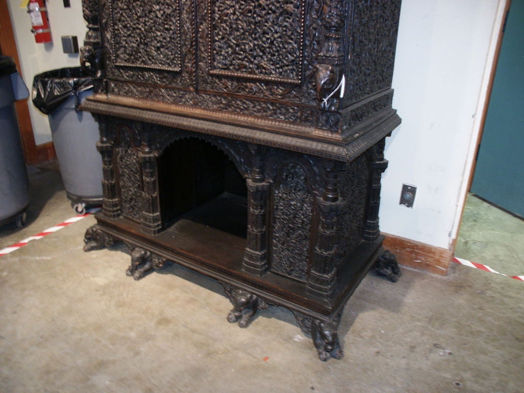 Stunning large carved and peirced cabinet with birds and elephants.  This would make a great TV Cabinet.  It really makes a statement and the quality of the carving is great. It is covered in leaves and flowers and birds and some lions.  The feet
