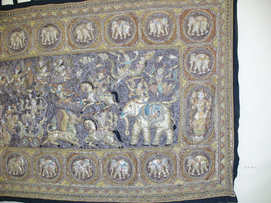 Stunning Large Burmese Kalagas Tapestry. This is covered in shwe-chi-doe and the colors are gold and silver and shades of lavender and green. This is covered in elephants and figures.