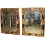 Pair of Baroque Style Parcel Gilt and Ebonized Mirrors