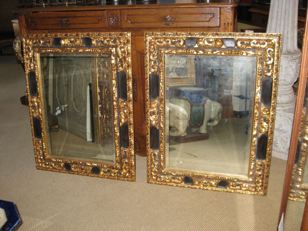 Pair of Baroque Style Parcel Gilt and Ebonized Mirrors