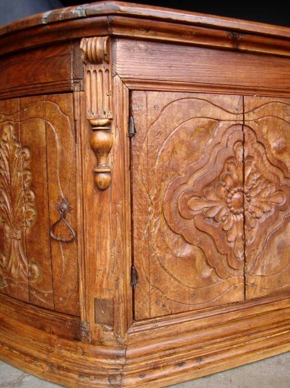 Originally a store counter with rounded sides and curved side doors, this piece was converted in the past from mostrador to buffet. It is finished on both sides with carved doors in front and carvings on backside. Can float in a room.