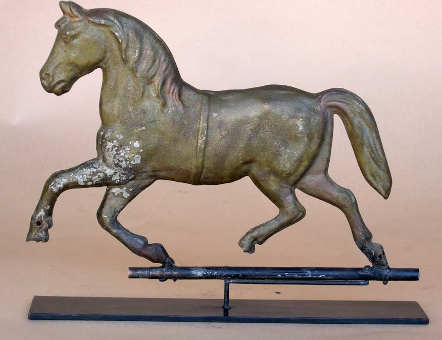 Antique trotting horse weather vane molded in zink coated tin. Contemporary hand wrought iron base.