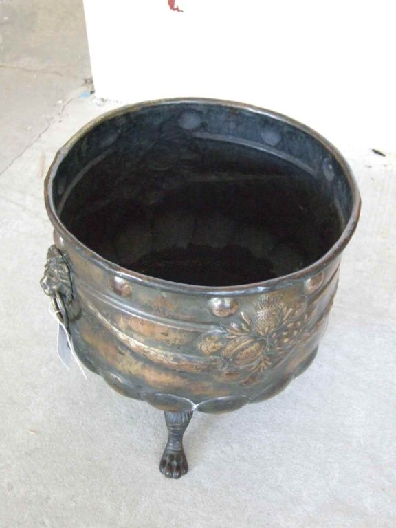 A Patinated Brass Repousee Firewood Vessel In Good Condition In Greenwich, CT