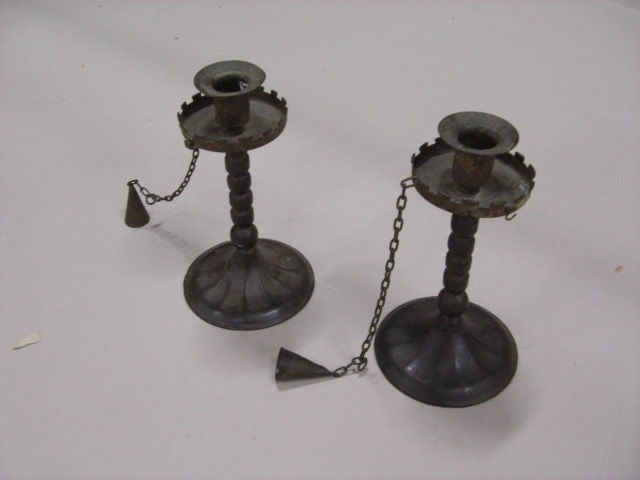 Unusual pair of 19th Century tin and ebonized wood candlesticks with crenelated drip pans, bobbin turned shafts and having original chained candle snuffs. Excellent patina.