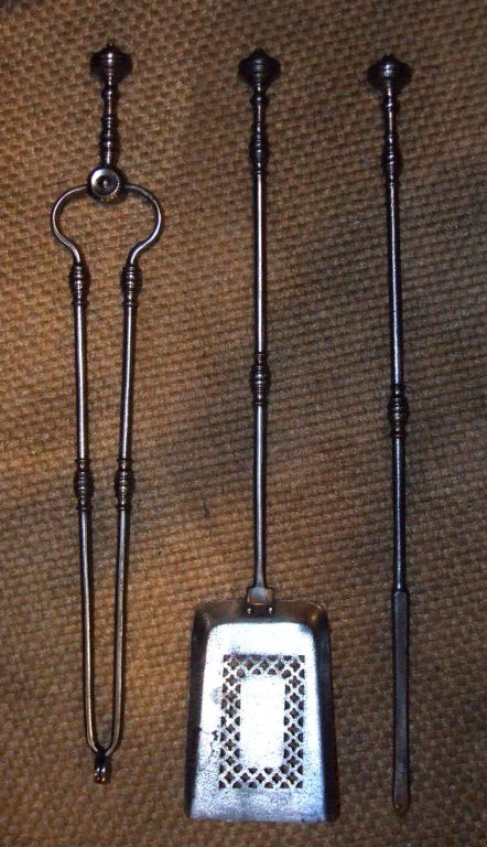 Set of George III steel firetools with ringed knob finial and turned shaft, the tongs with faceted hinge, the square shovel pierced with
diaper pattern in square border.
