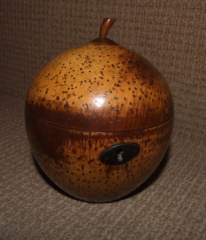 Rare English tea caddy in the form of a quince, retaining original hinge, lock, escution, stem and foil liner. This caddy has great patina and lovely form. More commonly found in apple and pear shapes, other fruit caddies are found including melons,