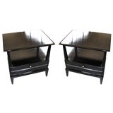 A sculptural pair of ebonized, mid-century tables