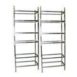A pair of chrome and gilt-iron etageres with glass shelves