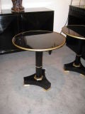 A pair ebonized tables on pedestal base