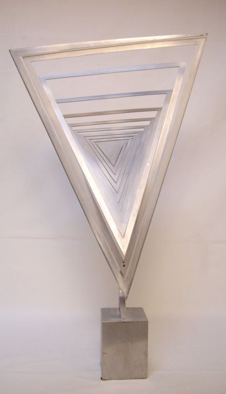 Kinetic aluminum sculpture by California artist Jerome Kirk.  Signed 'KIRK' on the base. Illustrated in 'KIRK' by Nori Nesbit 1987, pg. 50 (see photos)