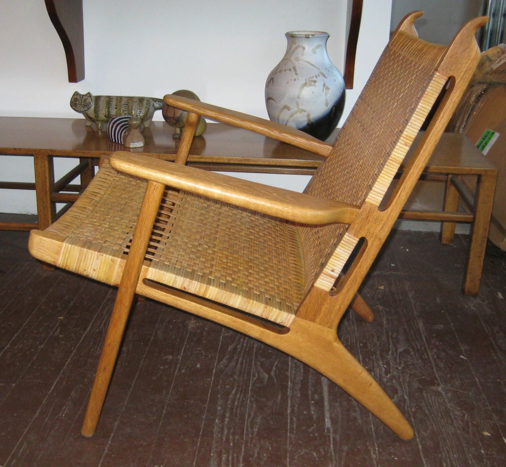 Teak, oak and cane arm chairs with original cane rushing.  In amazing original condition with beautiful patina on both the wood and cane. This chair has been out of production for many years.  Stamped 