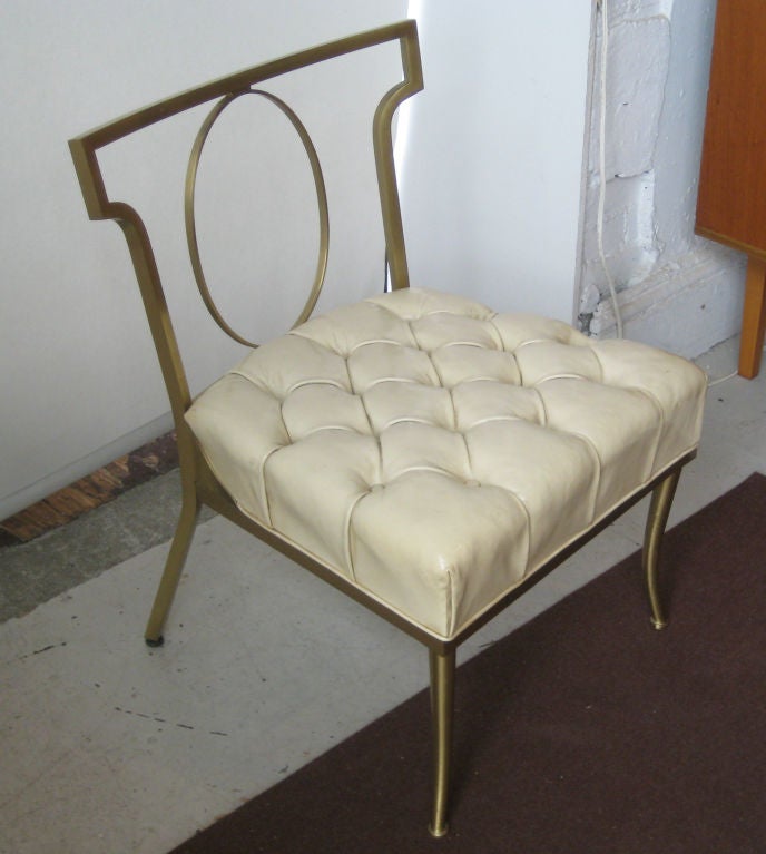 Chic slipper chair with brass tube frame and original cream tufted patent leather seat.  This listing is for a single chair.