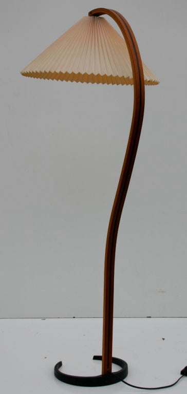 Bent teakwood and iron floor lamp with original shade.