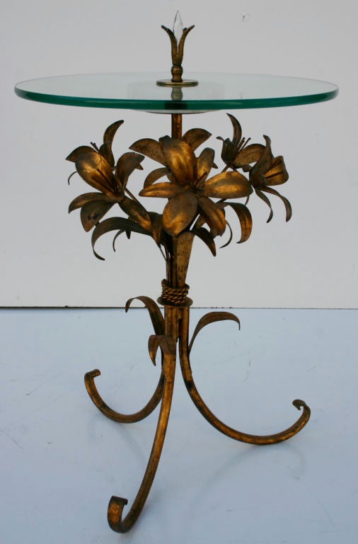 Charming gilt metal bunch of lilies tole table with glass plateau and marble; crystal finial.
