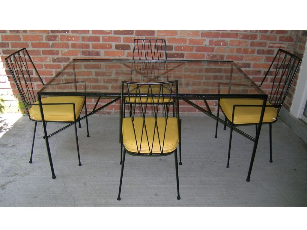 Patio set by Paul McCobb, Arbuck. Set includes dining table, four dining chairs, settee and pair of lounge chairs. In black iron and yellow naugahyde.