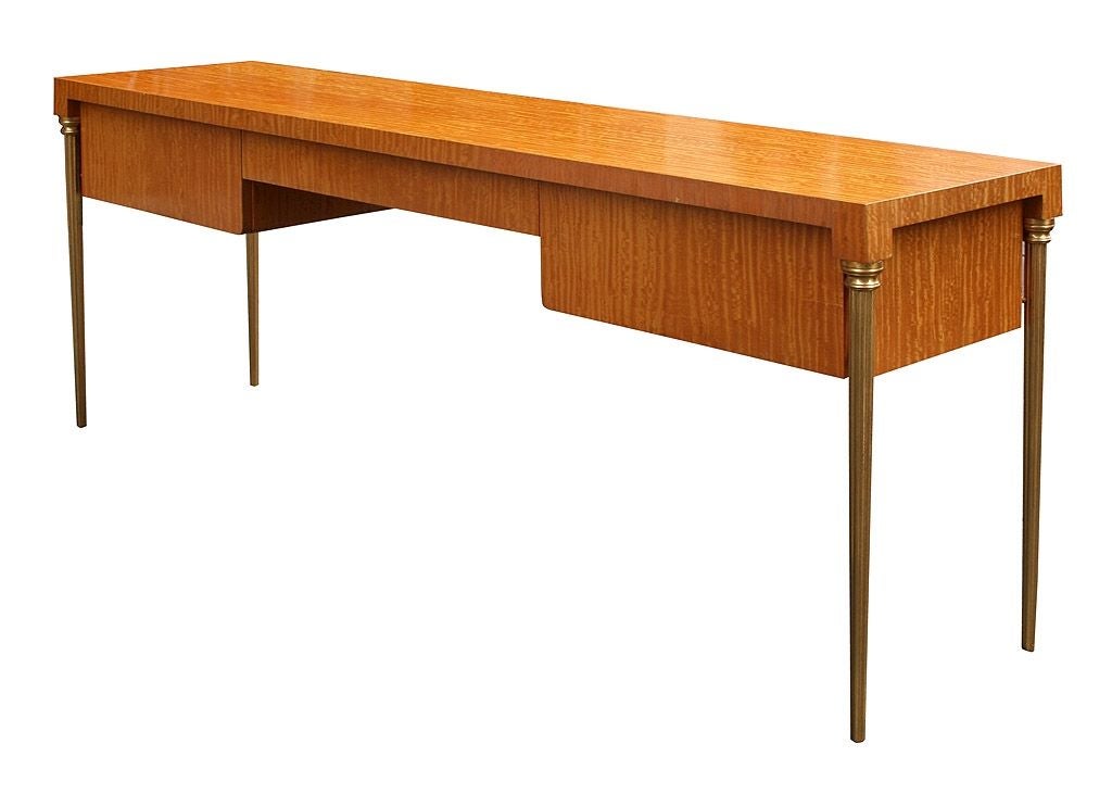 Exceptional Ceylon satinwood console by T.H. Robsjohn-Gibbings. From the Torno Penthouse designed by Philip Johnson. Slender, gilt bronze legs make this console appear to float. Three drawers. Provenance available.
