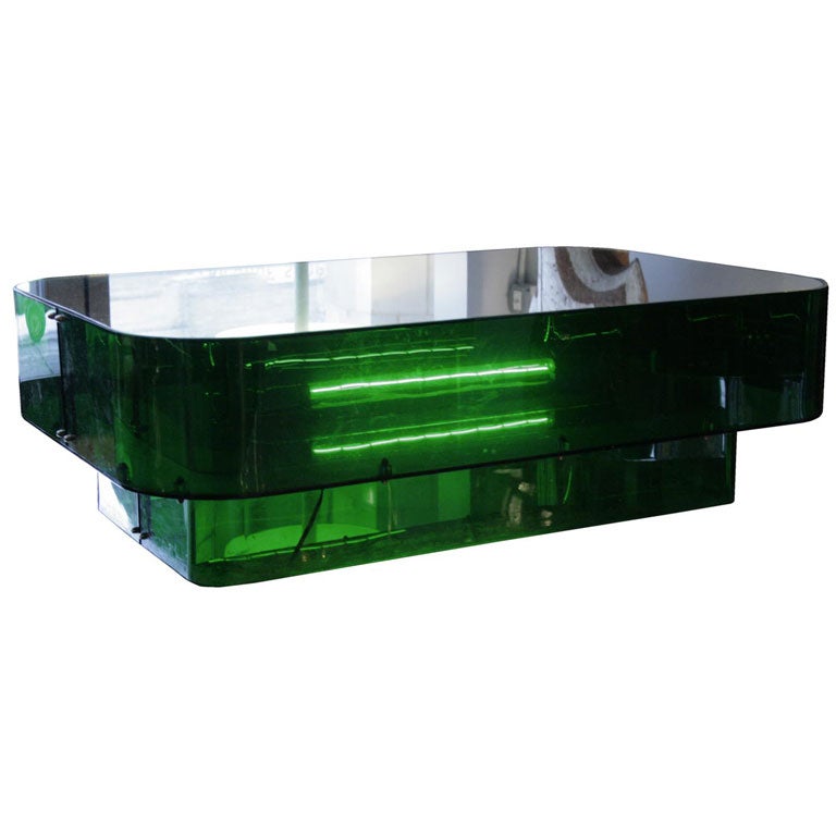 There are few designers who captured the essence of the Studio 54 era as well as Ron Ferri did. The emerald green plexiglass base is illuminated from within and rests on a sleek mirrored glass top. Pure disco chic.

From the original Jay Spectre