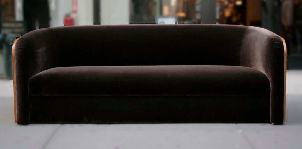 A zebra wood sofa by Karl Springer, c 1980.   Zebra wood wraps around the sofa, newly upholstered with 100% silk velvet in dark “mahogany” Nancy Corzine fabric.