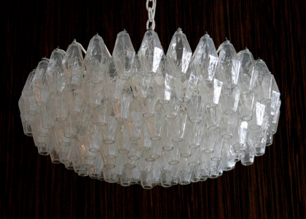 A clear polyhedral chandelier by Carlo Scarpa for Venini, circa 1950, in a disc form with seven shallow tiers.