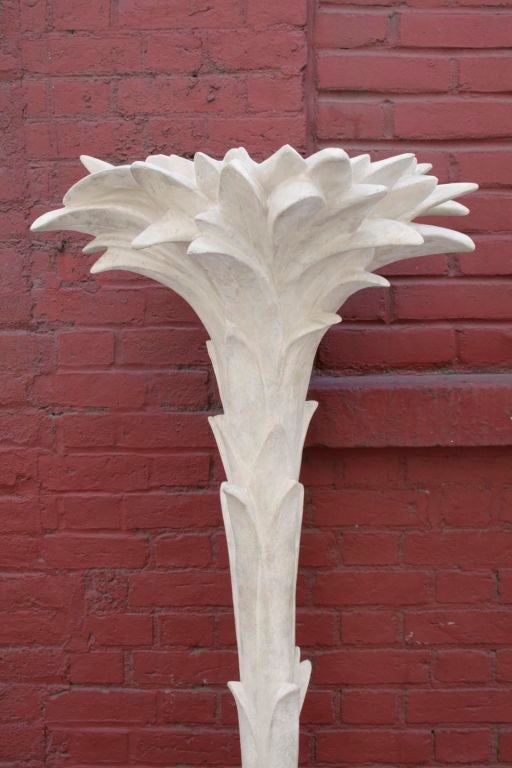 A Pair of plaster wall torcheres by Serge Roche, c. 1940s.  These torcheres were designed to go against a wall and are palm tree forms on a “rock” base, finished in Roche’s iconic off-white plaster. Please note their sizes slightly vary.<br />
72H