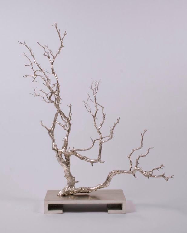 A silver leaf decorative object by James Mont, c 1950s.  A large tree branch silver leafed and heavily lacquered on a rectangular scroll form silver leaf wooden base.