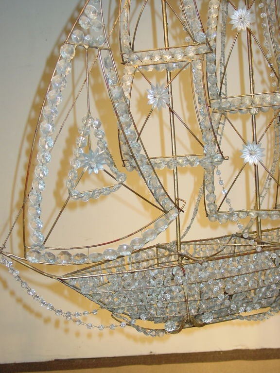 the three masted ship form structure applied with various faceted beads, stars and chains and fitted with six lamps