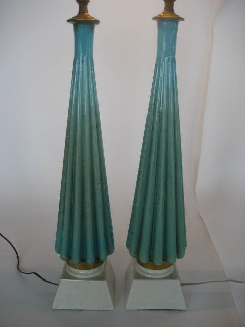A pair of turquoise, cased glass lamps. With gold flecks inside.