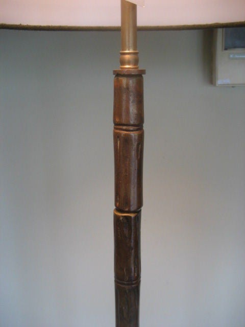 A great patinated brass floor lamp by Bagues with a tripod base.