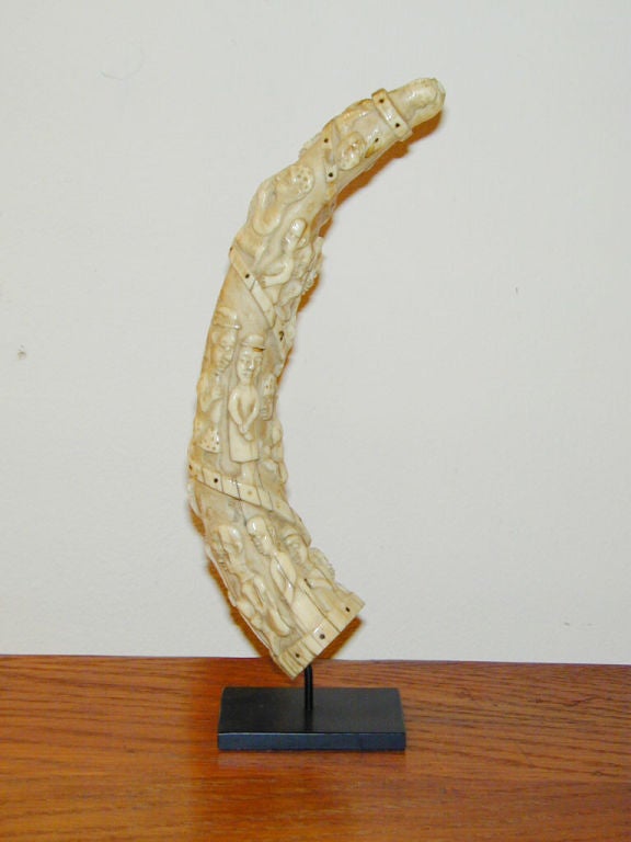 Late 19th century carved ivory tusk made by the Kongo peoples of central Africa's Loango coast (now the Congo Republic). Intricately carved in the typical fashion of a spiraling procession of figures in native and western costume.