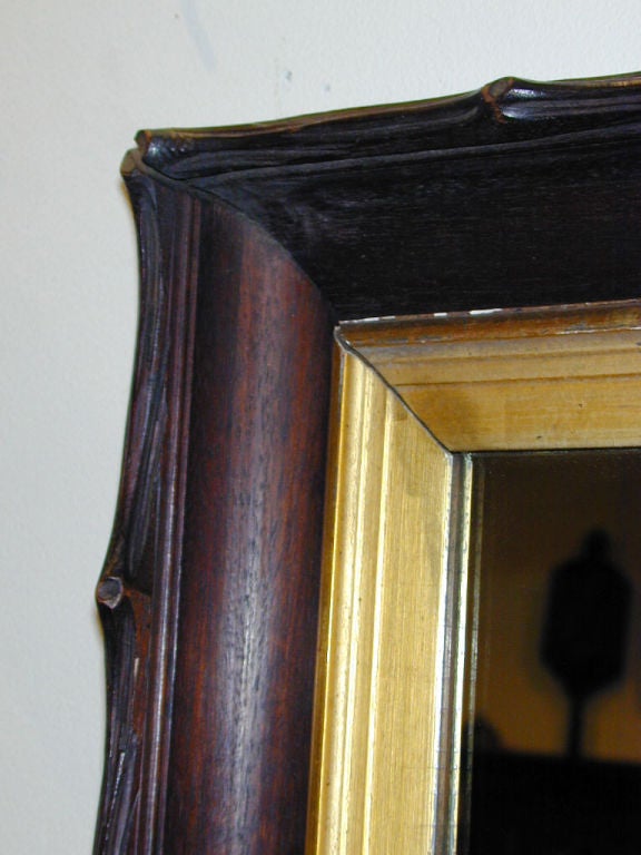 German Black Forest carved walnut mirror frame with gilt wood inset molding. The walnut carved realistically to resemble tree branches. 