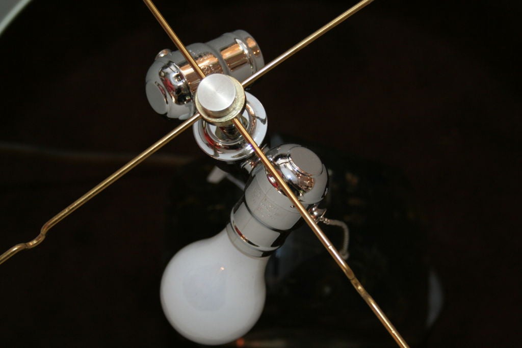 A modernist Lucite table lamp encased with clock works.
Shade not included
