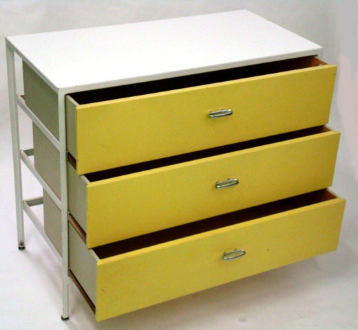 A pair of three-drawer chests from the steel frame series by George Nelson for Herman Miller with white enameled metal frames, white laminate tops, yellow lacquered drawer faces and elliptical chrome pulls, American, circa 1950.