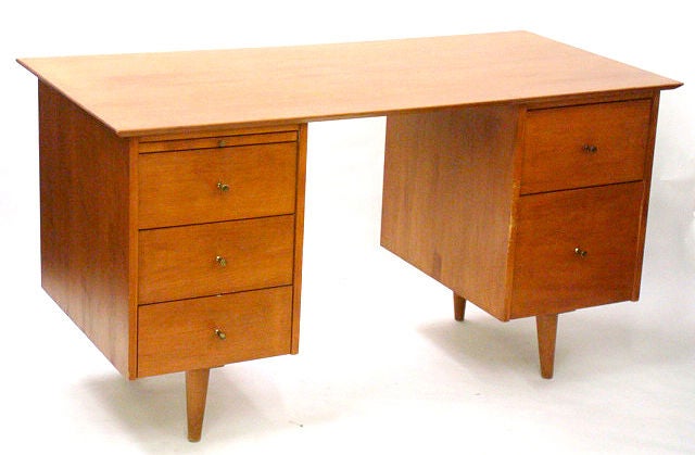 An excellent example of a double pedestal desk with vintage finish and solid brass 'golf tee' hardware. By Paul McCobb for the Planner Group line from Winchendon. U.S.A., circa 1950.