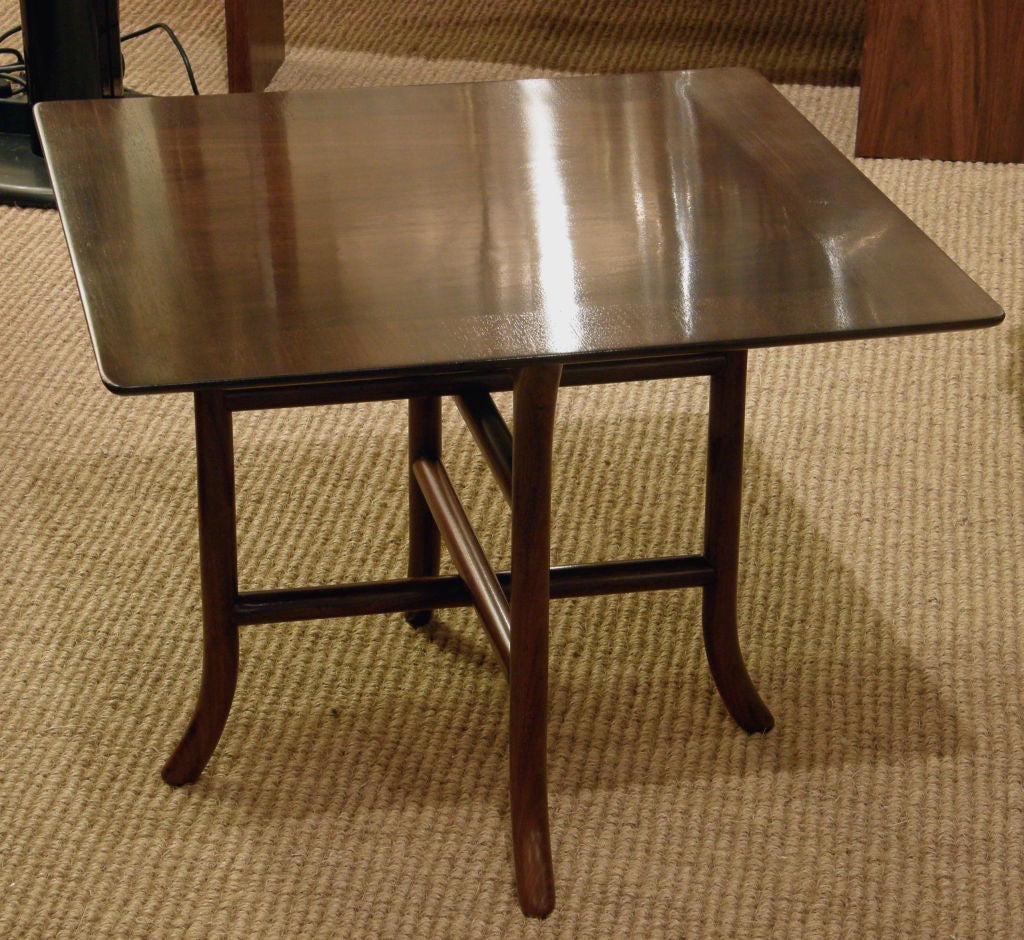A pair of walnut square drinks tables with out turned foot, and double leg stretcher supports, mod. no. 3335. By T.H. Robsjohn-Gibbings for Widdicomb. U.S.A., circa 1950. [DUF0147ABCD]