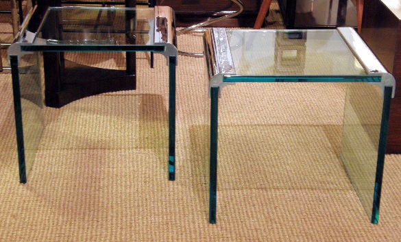 A chic pair of waterfall tables with three thick sections of tempered glass connected by a radiused polished chromed steel bracket by Pace. American, circa 1970.