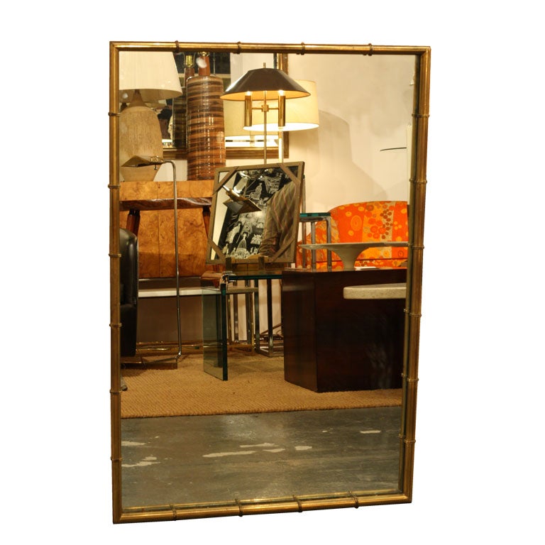 A rectangular mirror with brass 'bamboo' frame. U.S.A., circa 1960.