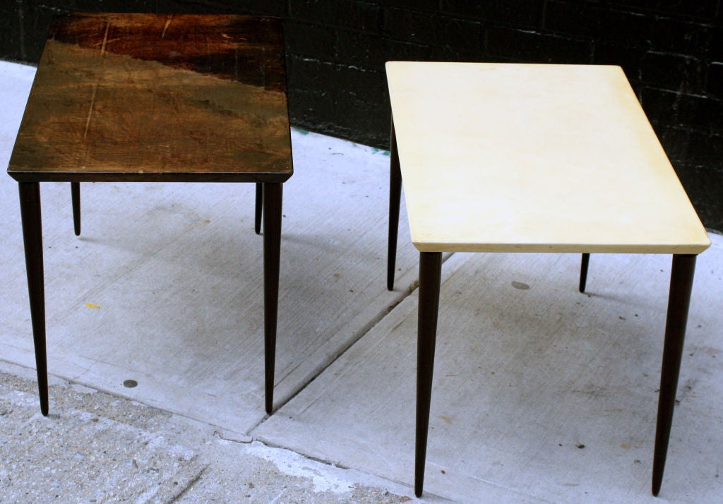 A pair of goat skin wrapped occasional tables in dark brown and natural finish with beveled edge and lacquered tapered dowel legs by Aldo Tura. Italian, circa 1950.