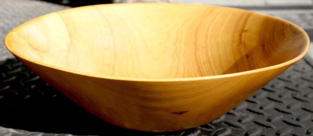 A beautiful bowl hand-carved out of a flat sawn solid piece of birch wood that is then carved parallel to the growth rings, which creates movement and fluidity. With carved signature “HN” to the bottom. By Harry Nohr. American, circa 1960.