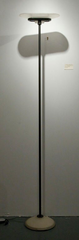 A tall and slender torchere with a race track shaped, frosted glass shade, an enameled metal post and a domed, frosted glass base, by King, Miranda, Arnaldi and produced by Arte Luce. Italian, circa 1979.