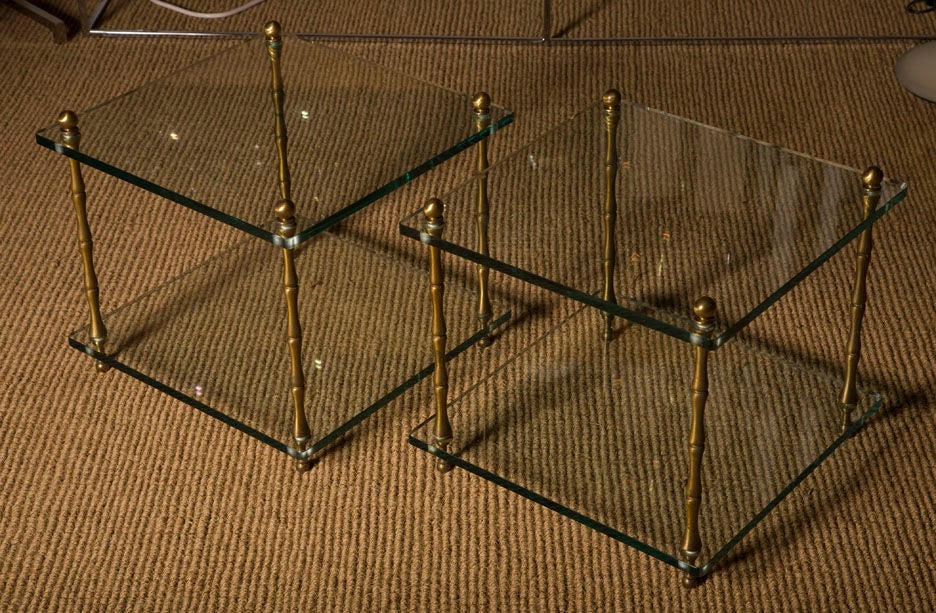 A pair of square occasional tables in glass with brass faux bamboo legs, U.S.A., circa 1960.