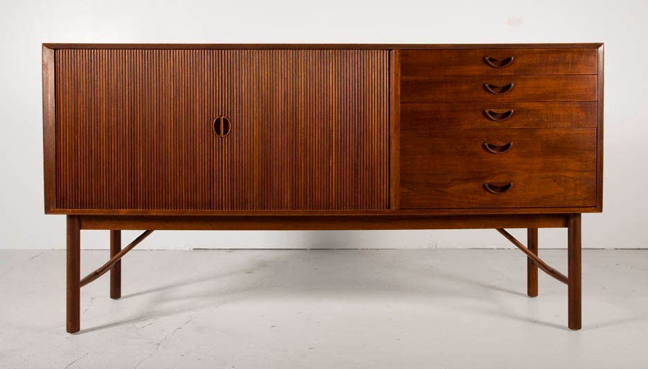 A sideboard in solid teak with two tambour doors, four drawers and expressed finger joint cabinetry by Peter Hvidt. Danish, circa 1950.