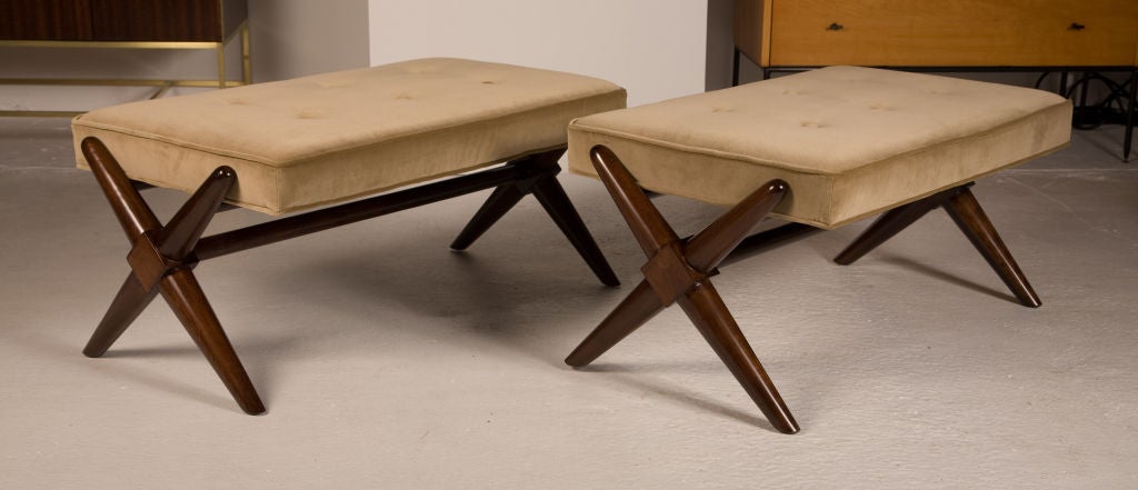 A pair of rectangular upholstered benches raised on walnut trestle bases, mod. no. 1683, by T.H. Robsjohn-Gibbings for Widdicomb. U.S.A., circa 1950. Price COM.