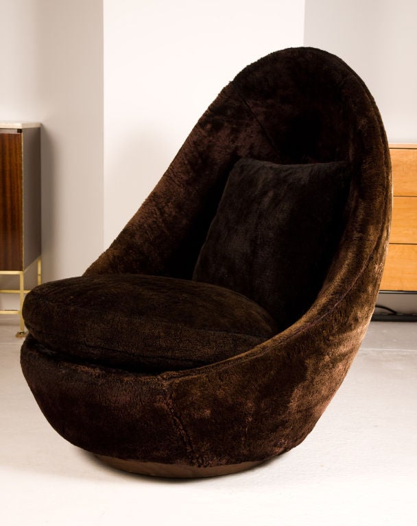A groovy upholstered swivel and tilt “egg” chair by Milo Baughman for Thayer Coggin. American, circa 1970.