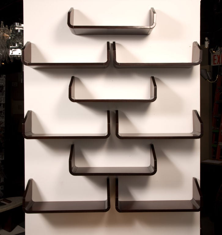 A set of nine shelves with blind screw mount hardware after Gio Ponti, American, circa 1950.