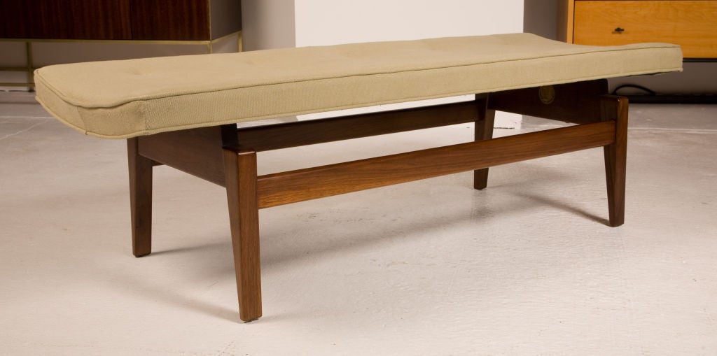 A pair of four foot long upholstered benches floating over a walnut frame with rectangular tapered legs, mod. no. U-620. By Jens Risom. U.S.A., circa 1950. [DUF0486]