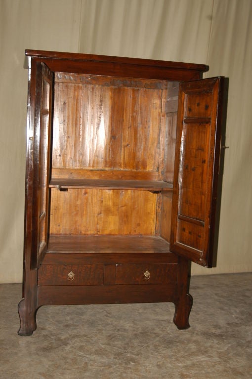 A refined and elegant ju mu wood armoire with framed burlwood doors, brass fitting, beautiful wood grain. View our website at: www.greenwichorientalantiques.com for additional armoire selections.