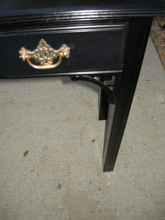 Chinese Chippendale three drawer console table.Original solid brass hardware,three pull out drawers.Fret detailing on front left and right,sleek carved legs,ebonized finish.