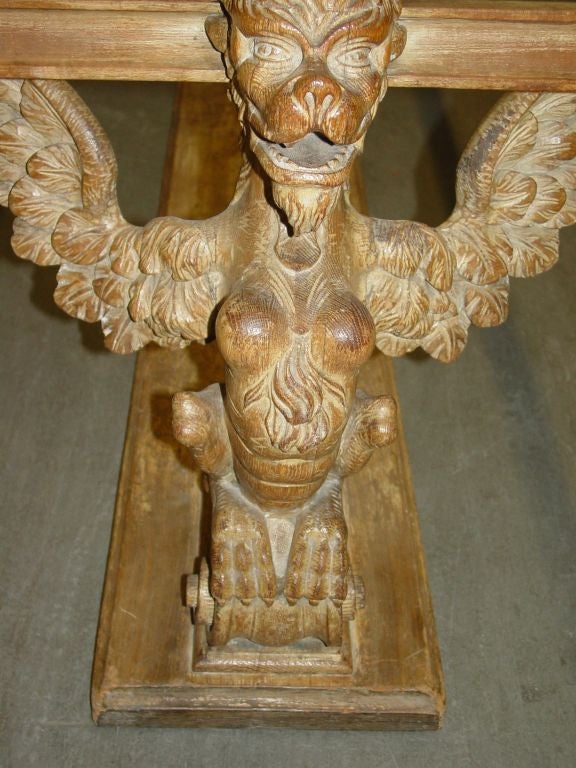 Dramatic hand carved walnut Griffin head coffee   table from Germany. Walnut wood used on frame and carvings.