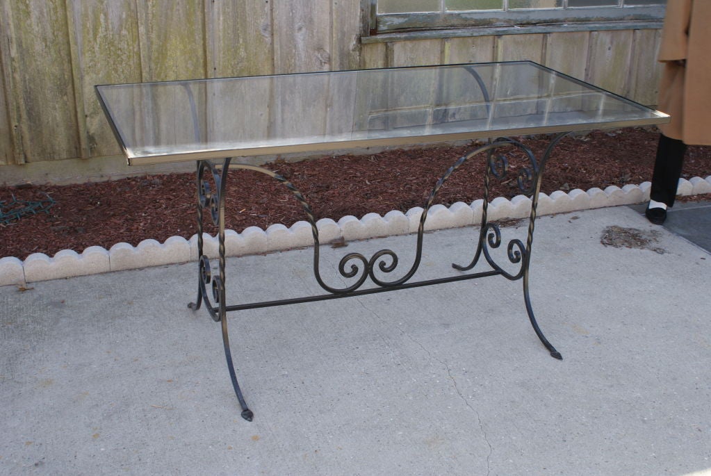 Black wrought iron and glass Woodard indoor or out door table.